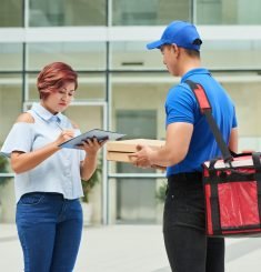 Woman signing receipt for food delivery